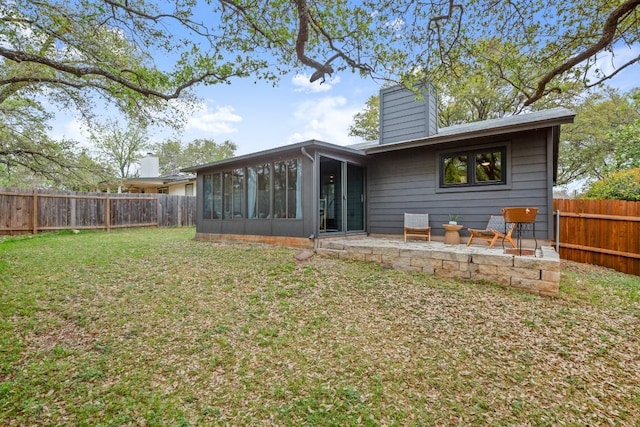 3503 Gable Dr, Austin, TX 78759 - back of property featuring a sunroom, a chimney, a fenced backyard, and a patio area
