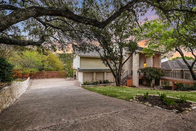 1607 Bay Hill Dr, Austin, TX 78746 - view of front of home featuring stairway, driveway, an attached garage, and brick siding
