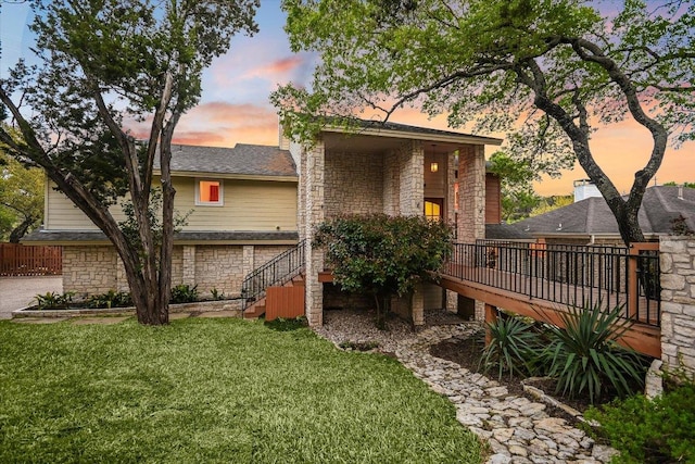 1607 Bay Hill Dr, Austin, TX 78746 - view of front of home featuring stone siding, a front lawn, and stairs