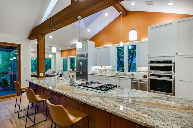 1607 Bay Hill Dr, Austin, TX 78746 - kitchen with appliances with stainless steel finishes, a sink, beamed ceiling, light wood-type flooring, and tasteful backsplash