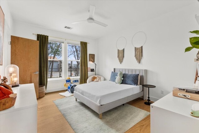 510 W 22nd St, Georgetown, TX 78626 - bedroom with ceiling fan and light wood-style floors