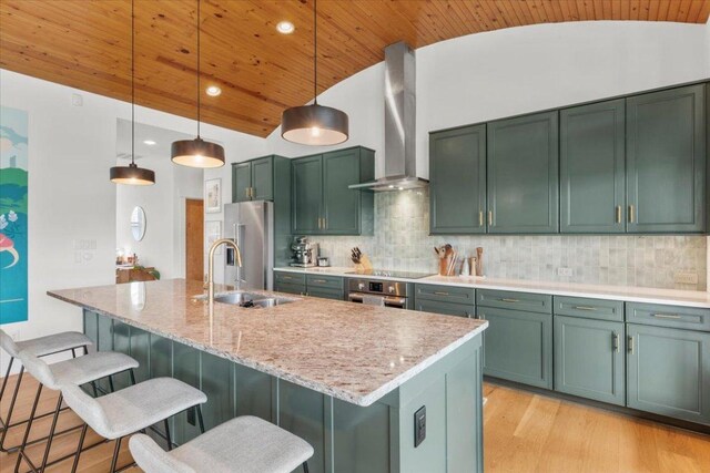 510 W 22nd St, Georgetown, TX 78626 - kitchen featuring wall chimney range hood, lofted ceiling, green cabinets, stainless steel appliances, and a sink