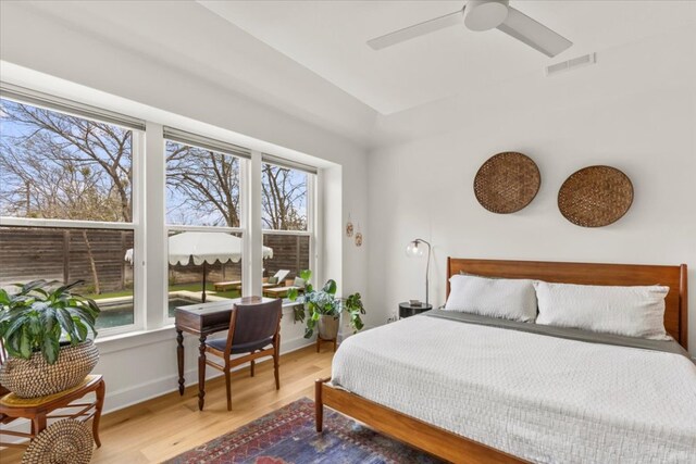 510 W 22nd St, Georgetown, TX 78626 - bedroom featuring multiple windows, wood finished floors, baseboards, and a ceiling fan