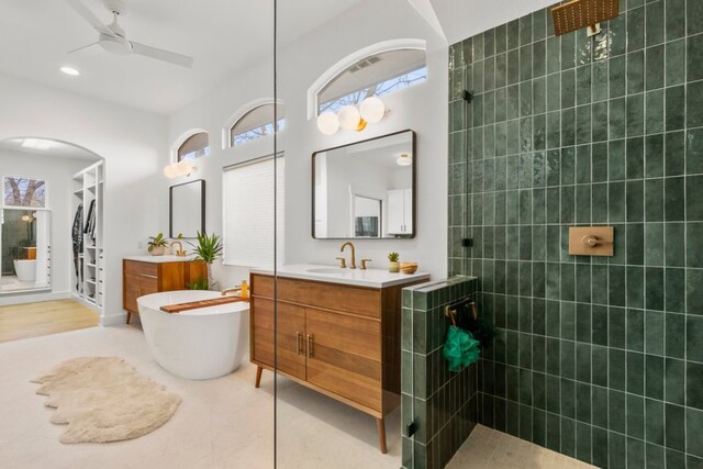 510 W 22nd St, Georgetown, TX 78626 - full bathroom featuring walk in shower, two vanities, a ceiling fan, and a freestanding bath