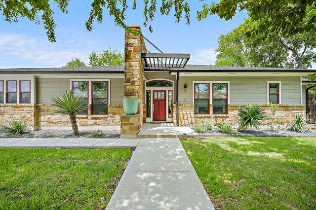 510 W 22nd St, Georgetown, TX 78626 - split level home with stone siding, a chimney, and a front lawn