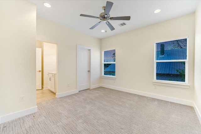1811 Cedar Ave, Austin, TX 78702 - unfurnished bedroom featuring light colored carpet, baseboards, recessed lighting, connected bathroom, and a ceiling fan