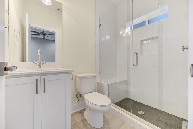 1811 Cedar Ave, Austin, TX 78702 - full bathroom featuring toilet, a stall shower, ceiling fan, vanity, and baseboards