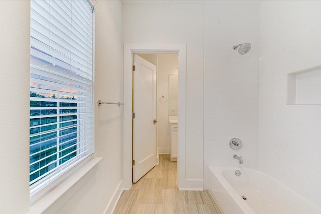 1811 Cedar Ave, Austin, TX 78702 - bathroom with washtub / shower combination, baseboards, and plenty of natural light