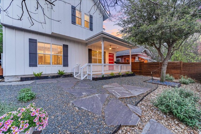 1811 Cedar Ave, Austin, TX 78702 - back of house at dusk featuring covered porch and board and batten siding