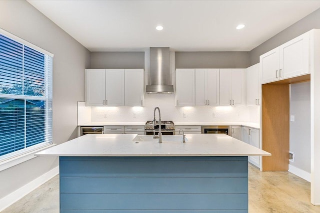 1811 Cedar Ave, Austin, TX 78702 - kitchen with wall chimney range hood, tasteful backsplash, an island with sink, white cabinetry, and finished concrete floors