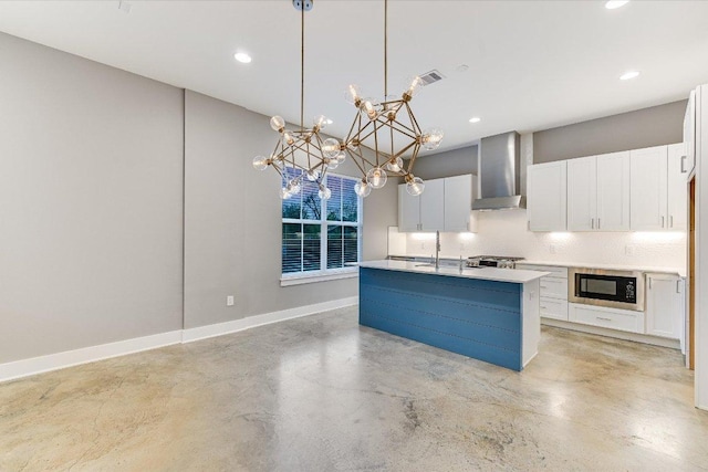 1811 Cedar Ave, Austin, TX 78702 - kitchen featuring wall chimney exhaust hood, black microwave, a chandelier, white cabinetry, and finished concrete floors