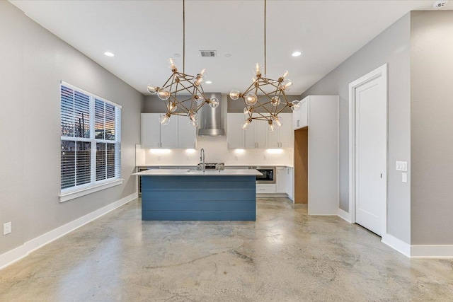 1811 Cedar Ave, Austin, TX 78702 - kitchen with wall chimney exhaust hood, white cabinets, concrete floors, a chandelier, and baseboards