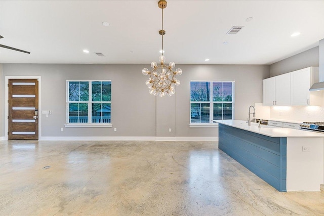 1811 Cedar Ave, Austin, TX 78702 - kitchen featuring concrete flooring, white cabinets, baseboards, pendant lighting, and recessed lighting