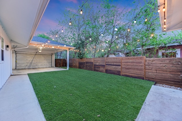 1811 Cedar Ave, Austin, TX 78702 - yard at dusk with a patio and a garage