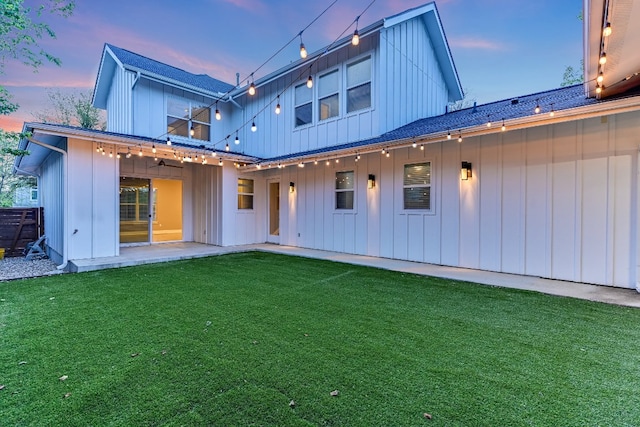 1811 Cedar Ave, Austin, TX 78702 - rear view of property with board and batten siding, a yard, and a patio area