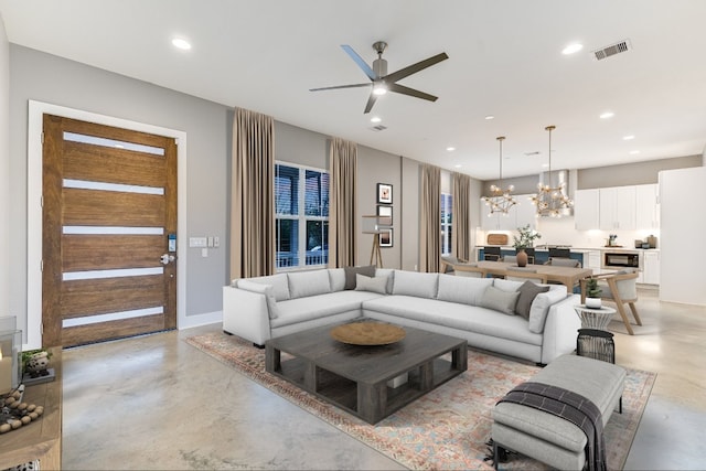 1811 Cedar Ave, Austin, TX 78702 - living room featuring concrete floors, ceiling fan, a chandelier, recessed lighting, and baseboards
