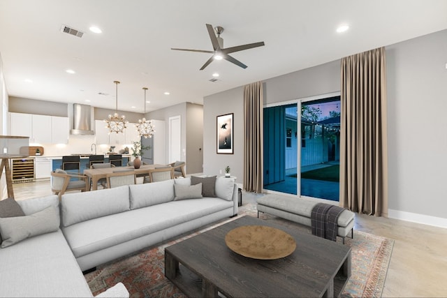 1811 Cedar Ave, Austin, TX 78702 - living room with wine cooler, concrete flooring, a chandelier, a ceiling fan, and recessed lighting