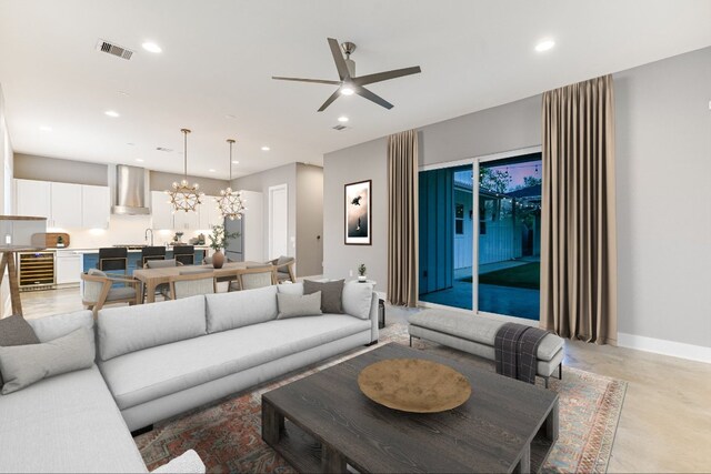 1811 Cedar Ave, Austin, TX 78702 - living room featuring wine cooler, concrete flooring, a chandelier, a ceiling fan, and recessed lighting