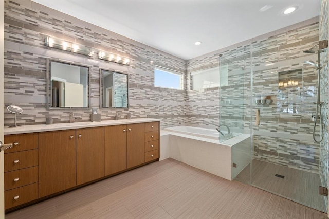 101 Knarr St, Austin, TX 78734 - bathroom featuring double vanity, a garden tub, tile walls, a shower stall, and recessed lighting