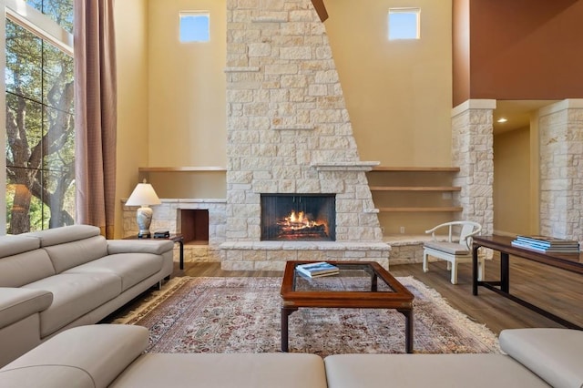 101 Knarr St, Austin, TX 78734 - living area featuring a towering ceiling, a fireplace, and wood finished floors