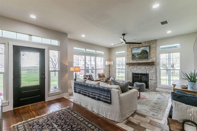 18190 Round Hall Rd, Holland, TX 76534 - living room with recessed lighting, wood-type flooring, visible vents, a ceiling fan, and a stone fireplace