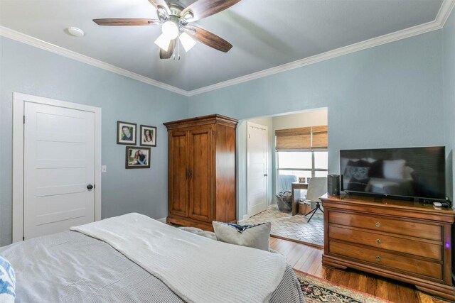 18190 Round Hall Rd, Holland, TX 76534 - bedroom with ornamental molding, a ceiling fan, and wood-type flooring