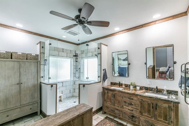 18190 Round Hall Rd, Holland, TX 76534 - bathroom with ceiling fan, a sink, a tile shower, and ornamental molding
