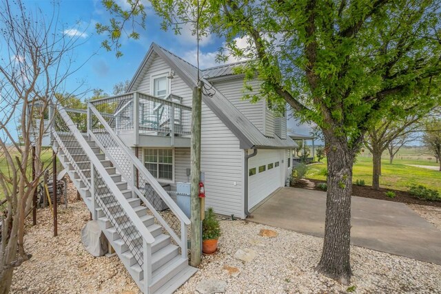 18190 Round Hall Rd, Holland, TX 76534 - view of front of home featuring concrete driveway, stairs, and metal roof