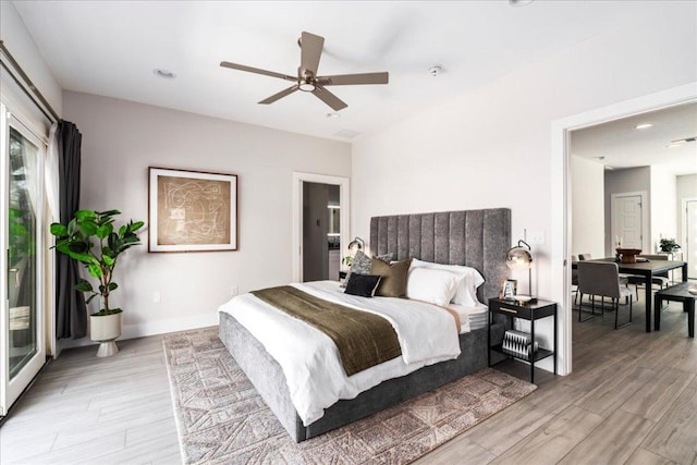 bedroom featuring light wood-style floors, multiple windows, and baseboards