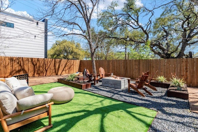 fenced backyard with an outdoor fire pit
