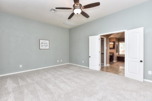 8016 Tahoe Parke Cir, Austin, TX 78726 - unfurnished bedroom featuring carpet flooring, baseboards, a ceiling fan, and ensuite bathroom