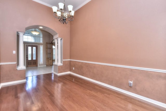 8016 Tahoe Parke Cir, Austin, TX 78726 - entrance foyer featuring ornate columns, arched walkways, ornamental molding, baseboards, and wood finished floors