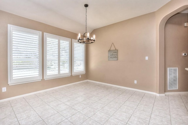 8016 Tahoe Parke Cir, Austin, TX 78726 - spare room featuring arched walkways, a chandelier, light tile patterned flooring, vaulted ceiling, and baseboards
