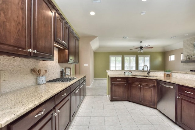 8016 Tahoe Parke Cir, Austin, TX 78726 - kitchen with stainless steel appliances, a sink, a ceiling fan, light tile patterned flooring, and decorative backsplash
