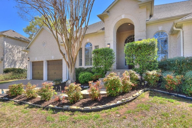 8016 Tahoe Parke Cir, Austin, TX 78726 - view of front of property featuring brick siding, a garage, driveway, and roof with shingles