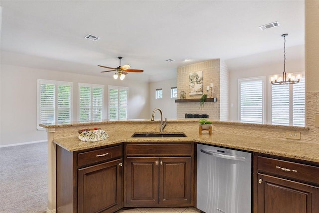 8016 Tahoe Parke Cir, Austin, TX 78726 - kitchen with stainless steel dishwasher, ceiling fan, light stone counters, and a chandelier