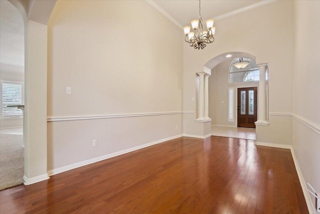 8016 Tahoe Parke Cir, Austin, TX 78726 - entryway with plenty of natural light, ornate columns, arched walkways, wood finished floors, and ornamental molding
