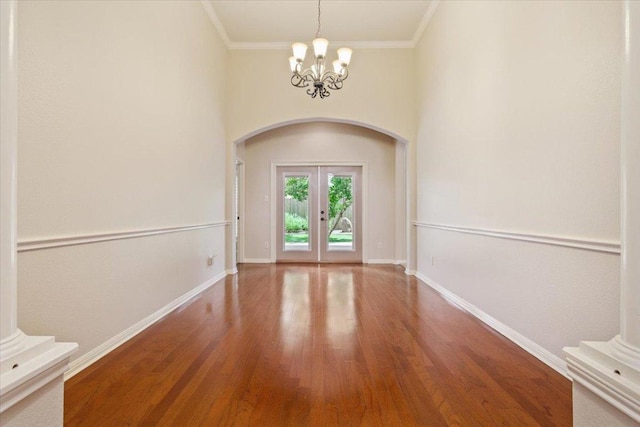 8016 Tahoe Parke Cir, Austin, TX 78726 - foyer entrance with arched walkways, french doors, wood finished floors, a chandelier, and crown molding