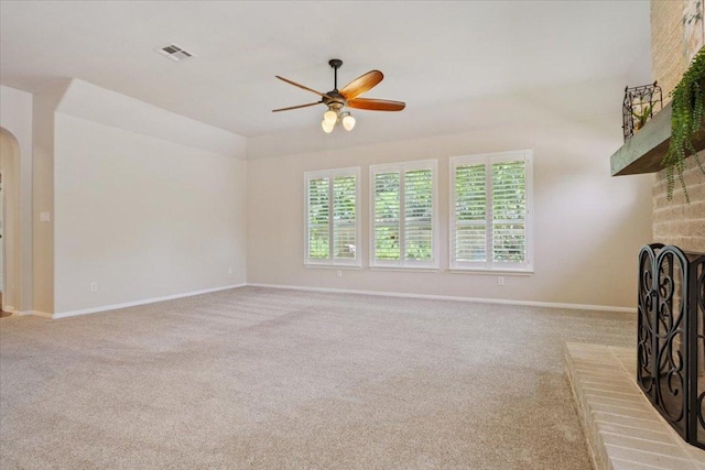 8016 Tahoe Parke Cir, Austin, TX 78726 - unfurnished living room with a fireplace, a ceiling fan, carpet, and arched walkways
