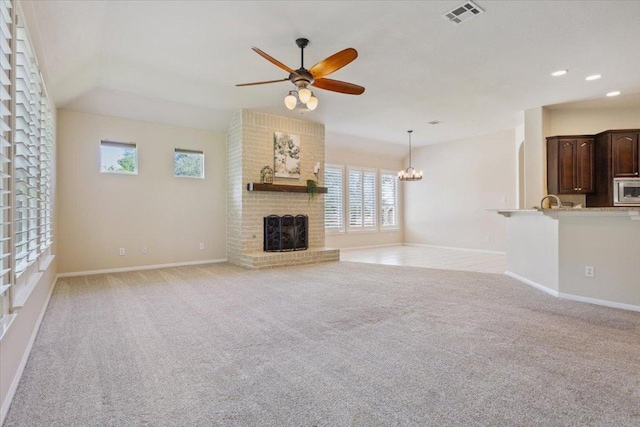 8016 Tahoe Parke Cir, Austin, TX 78726 - unfurnished living room with a ceiling fan, light colored carpet, a brick fireplace, recessed lighting, and a chandelier