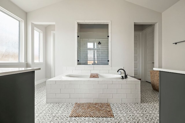 8112 Hubble Walk, Austin, TX 78744 - full bath with lofted ceiling, a bath, and tile patterned flooring