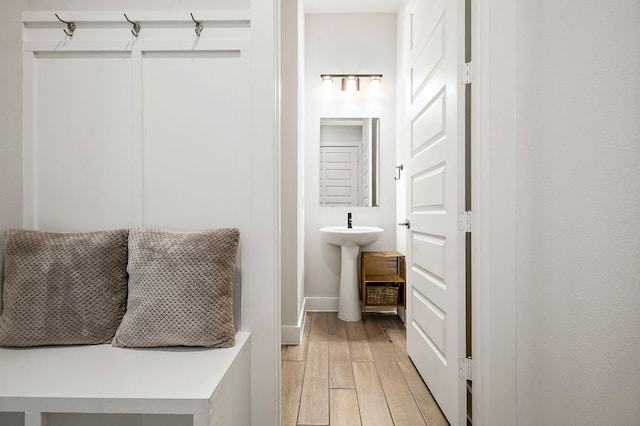8112 Hubble Walk, Austin, TX 78744 - mudroom with light wood-type flooring, a sink, and baseboards
