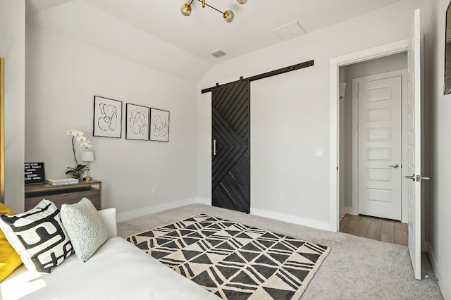 8112 Hubble Walk, Austin, TX 78744 - bedroom featuring carpet flooring, a barn door, baseboards, and lofted ceiling