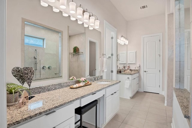 5141 Cornetto Blfs, Round Rock, TX 78665 - bathroom with a shower stall, two vanities, and tile patterned flooring