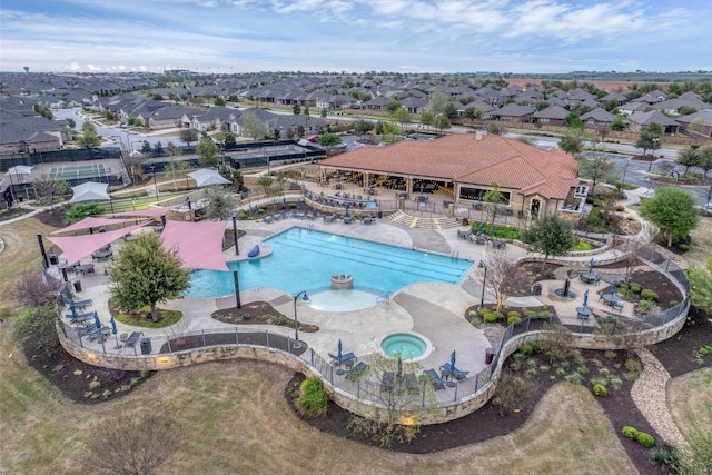 community pool featuring a residential view, a patio area, and a community hot tub