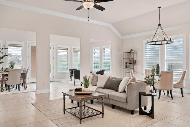 living area featuring ceiling fan with notable chandelier, light tile patterned floors, ornamental molding, vaulted ceiling, and baseboards