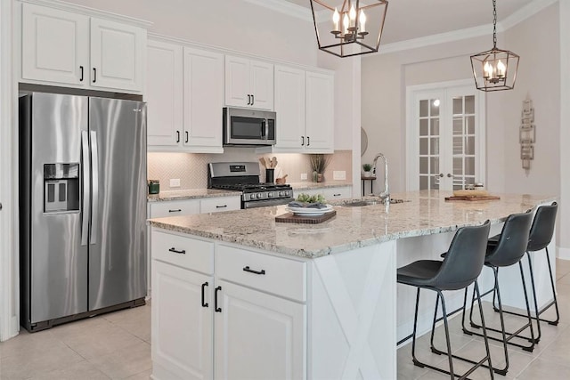 kitchen with an inviting chandelier, light tile patterned floors, and stainless steel appliances