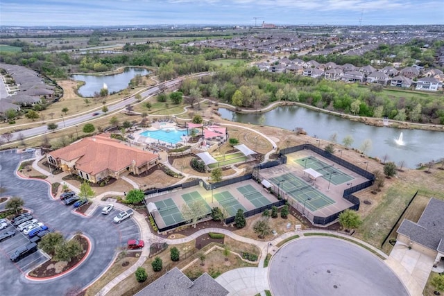drone / aerial view with a water view and a residential view