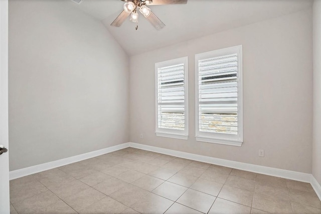 spare room featuring light tile patterned flooring, ceiling fan, baseboards, and vaulted ceiling
