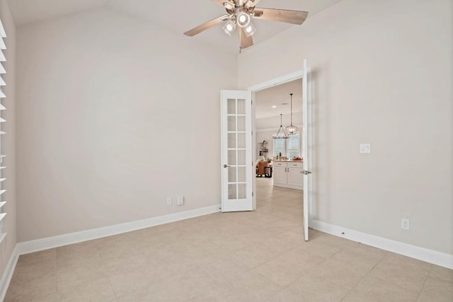 unfurnished room with french doors, ceiling fan with notable chandelier, baseboards, and light tile patterned floors